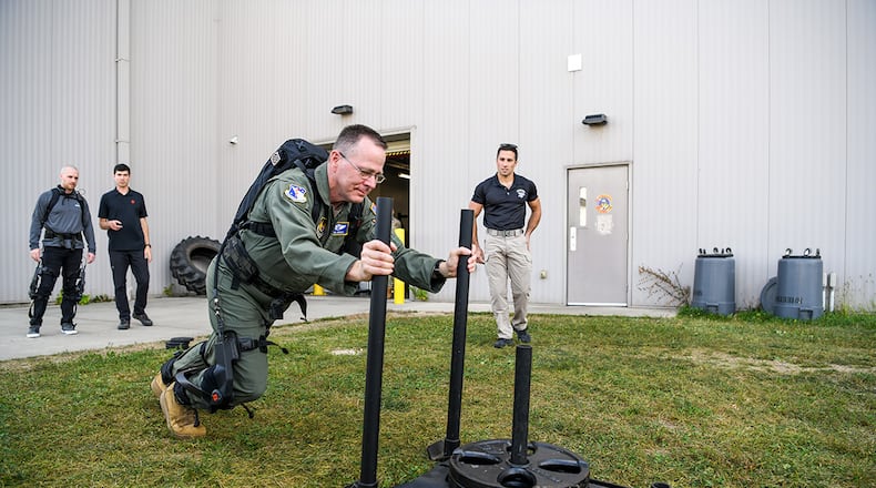 Brig. Gen. John Andrus, commander of 711th Human Performance Wing in the Air Force Research Laboratory, pushes a weighted sled while wearing the pneumatically powered exoskeleton during an AFRL demonstration Oct. 6 at the Air Force Reserve Command’s 445th Airlift Wing, Wright-Patterson Air Force Base. This technology, supported by AFRL’s Center for Rapid Innovation, was designed to assist aerial porters load and unload heavy cargo and is intended to minimize manpower needed as well as prevent injuries. (U.S. Air Force photo / Patrick O’Reilly)