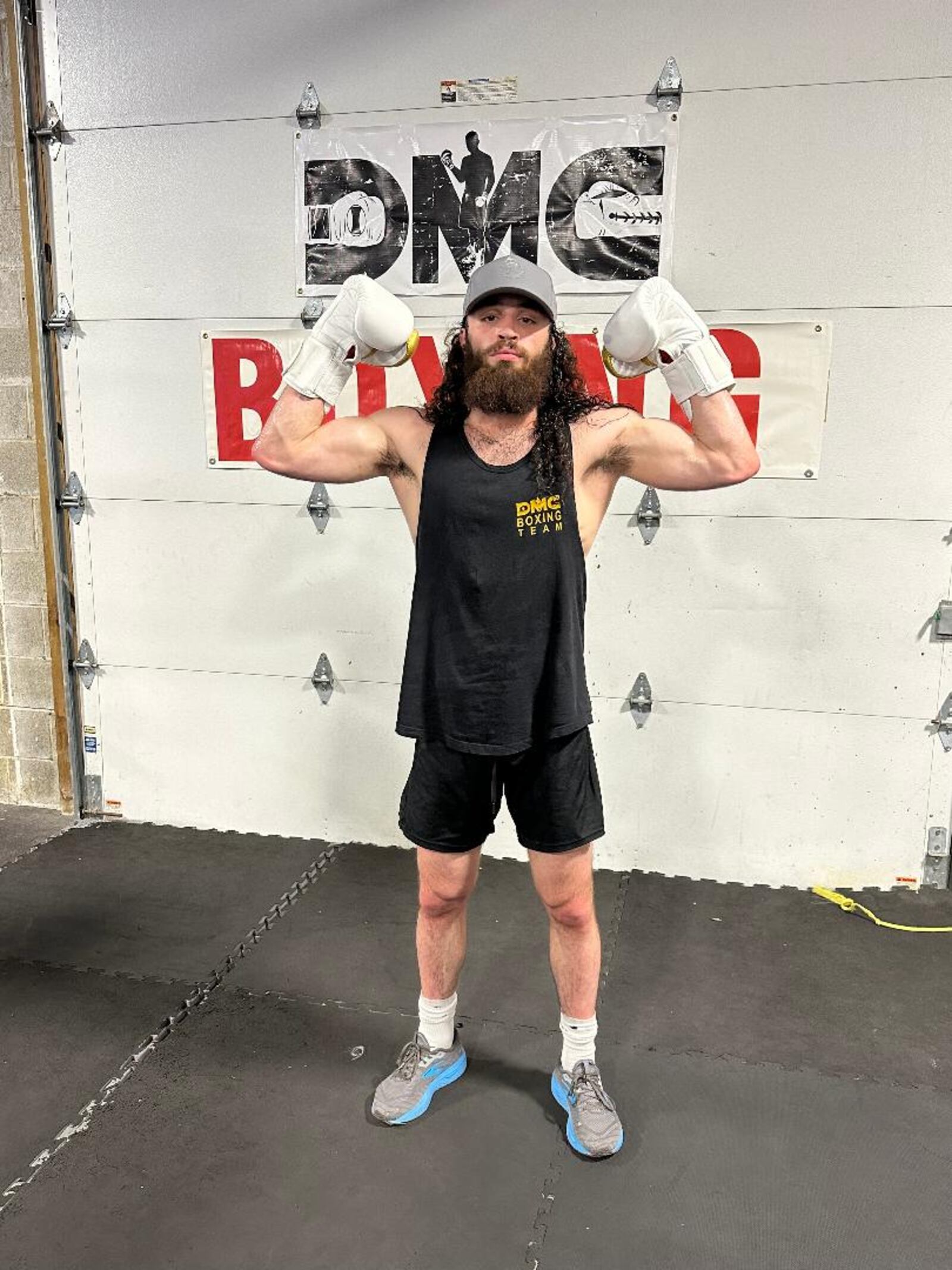Andrew Zammit (known in gym as Jrue King) gives a muscle pose at the DMC Boxing Academy in Centerville on Wednesday night. Zammit has qualified to fight in the Olympic Trials in Louisiana in early December. CONTRIBUTED