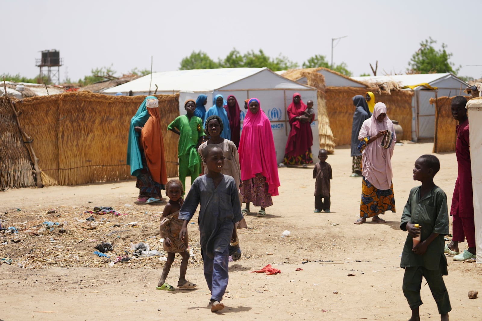 Women and children displaced by Boko haram attacks are seen outside there camp in Dikwa, north east Nigeria, April 29, 2025. (AP Photo/Sunday Alamba)