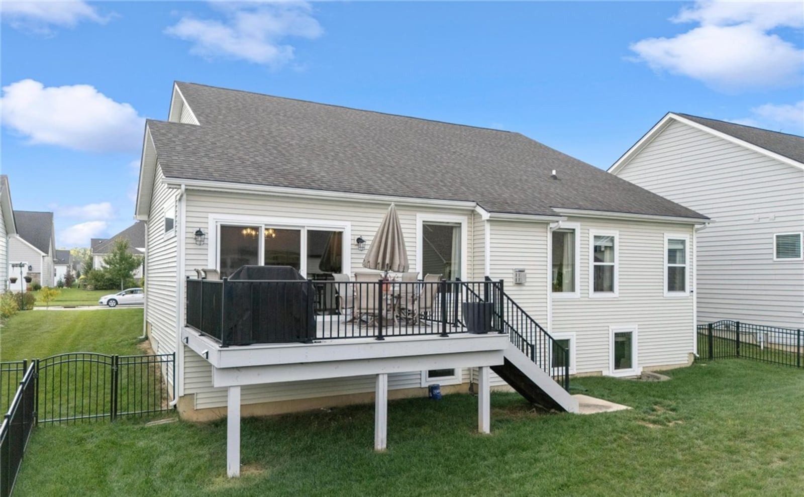 The back yard is fully fenced and has a wood deck off the dining room. The deck has metal railings and steps down to a concrete pad. CONTRIBUTED
