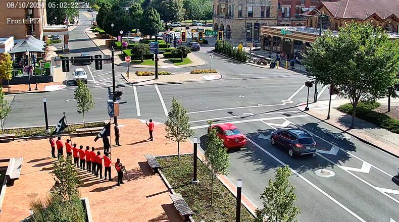 A still image taken from a city of Springfield video camera shows a group carrying Nazi flags and guns demonstrating on the Springfield City Hall plaza at 5 p.m. Aug. 10.