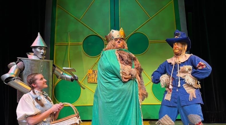 Allison Gabert (Dorothy) with Jonathan Pendergrass (Tin Man), Nate Marcum (Lion) and Dylan Jackson (Scarecrow) in La Comedia Dinner Theatre's production of "The Wizard of Oz." PHOTO BY JUSTIN WALTON