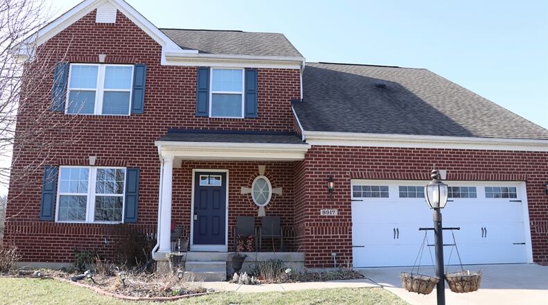 The brick-and-vinyl, 2-story home was built in 2014 and has about 3,690 sq. f.t of living space plus a finished basement. The half-acre property has a wooded back yard, paver patio and a 2-car garage with an extra parking pad. CONTRIBUTED PHOTO BY KATHY TYLER