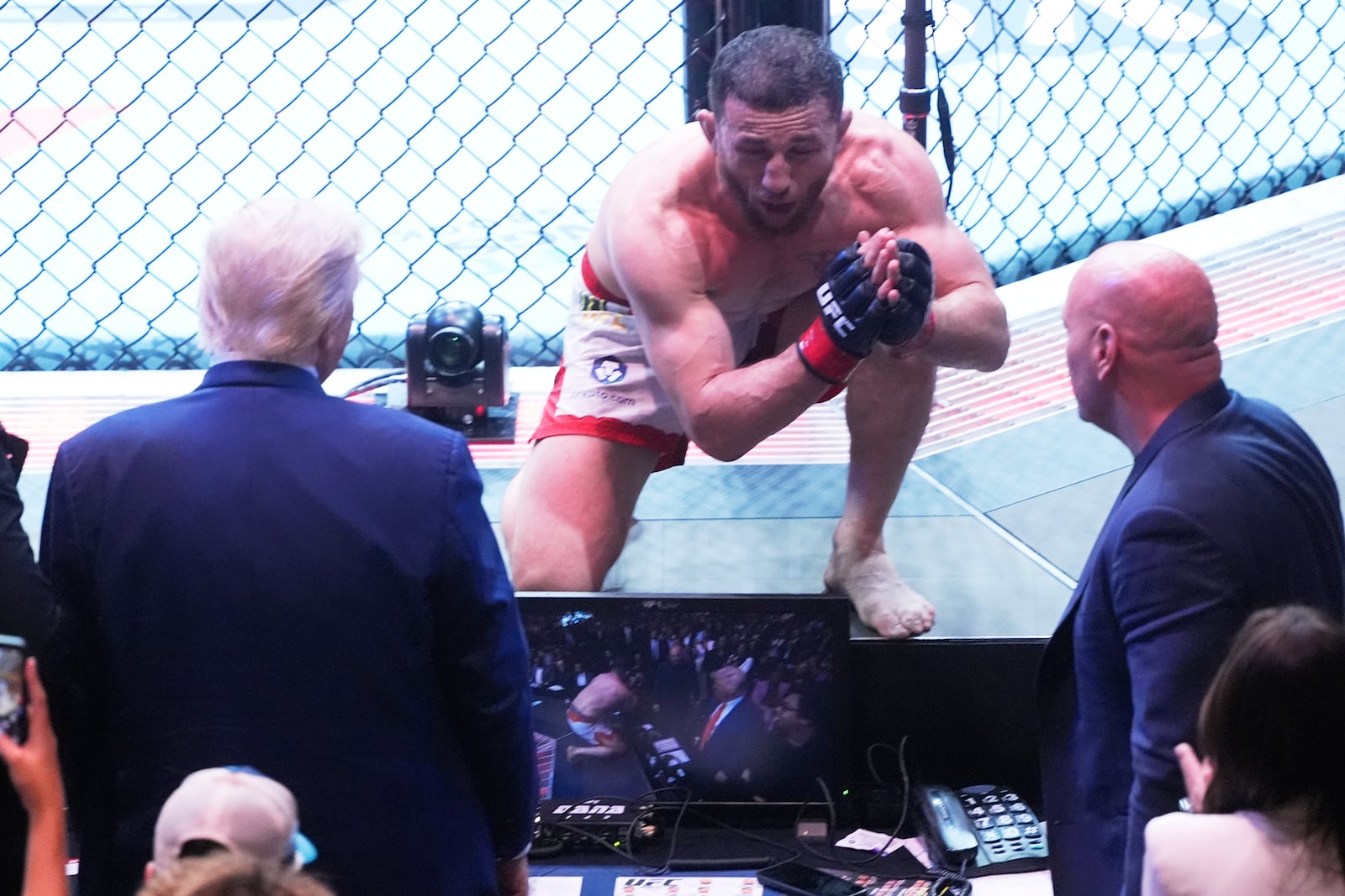 President Donald Trump congratulates Georgia's Merab Dvalishvili, after he won his bantamweight title bout against Sean O'Malley, during the UFC-316 mixed martial arts event, at the Prudential Center, Saturday, June 7, 2025, in Newark, N.J. (AP Photo/Manuel Ceneta)