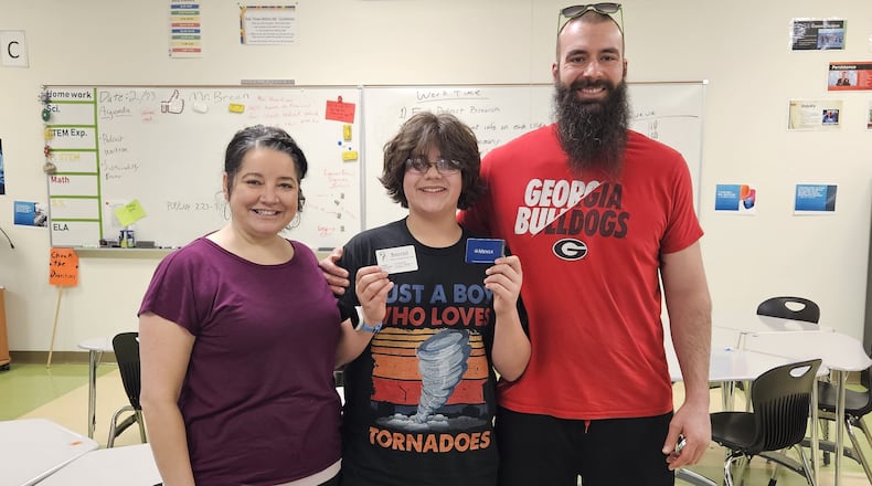 Lathan McKeel stands with his parents Char and Matthew. JESSICA GRAUE/STAFF