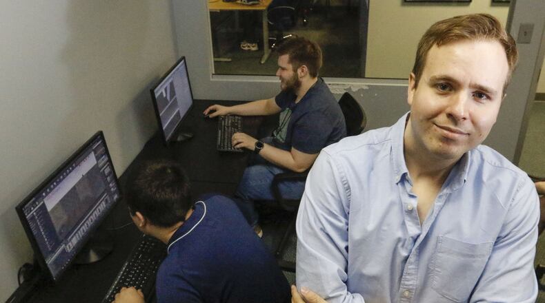 Kyle Barton, standing, who is on the autism spectrum, is a graduate and instructor at the nonPareil Institute in Plano, Texas. The institute is a non-profit that helps adults with autism through technical, vocational and social training. Shown on Wednesday May 2, 2018 are Iain Morrison, front, and Jake Raybon in the Unreal World Builder I class, where students learn a software used to create video games. (Ron Baselice/ Dallas morning News/TNS)