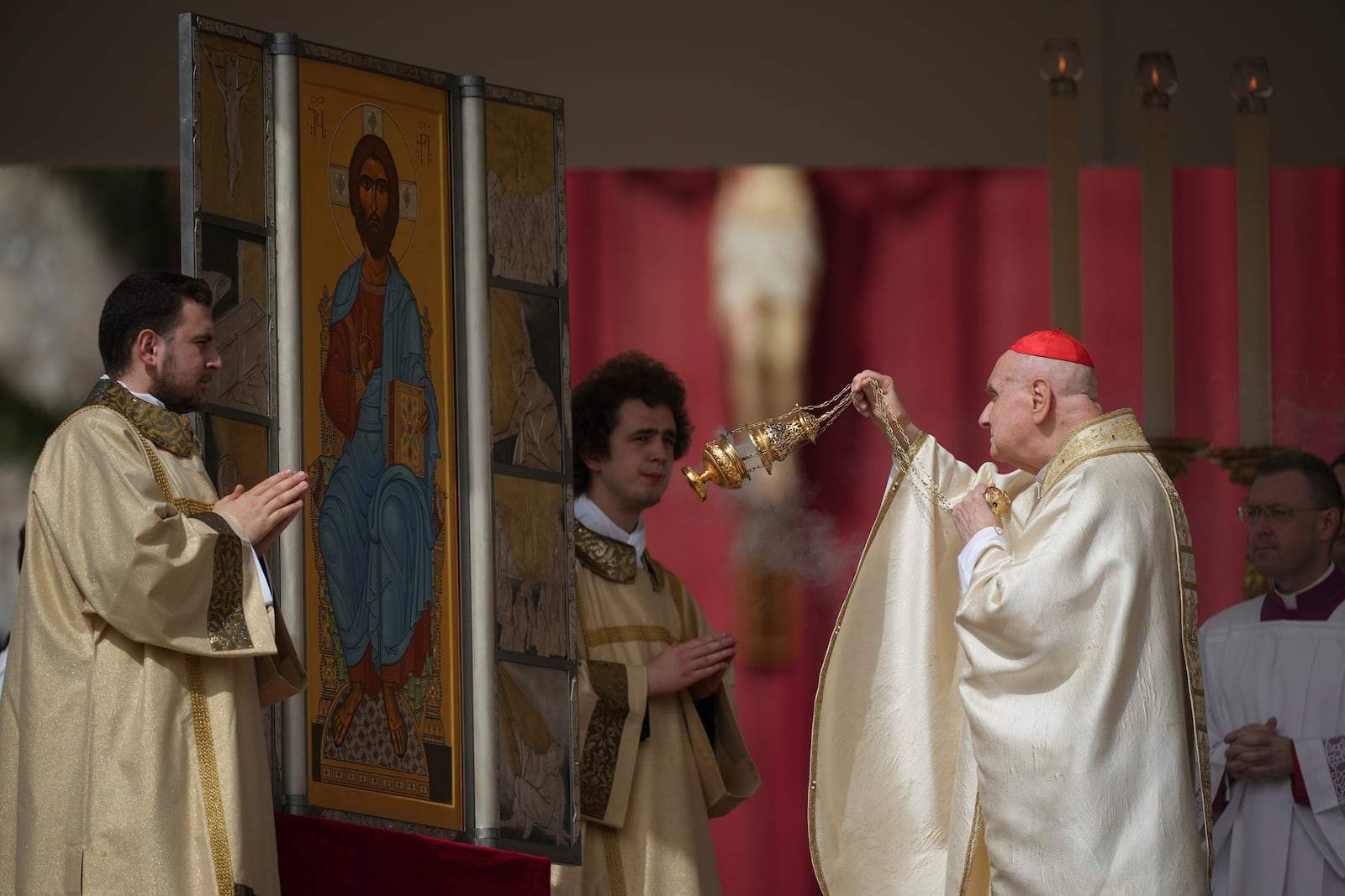 Cardinal Angelo Comastri, right, presides over the Easter mass in St. Peter's Square at the Vatican Sunday, April 20, 2025. (AP Photo/Andrew Medichini)