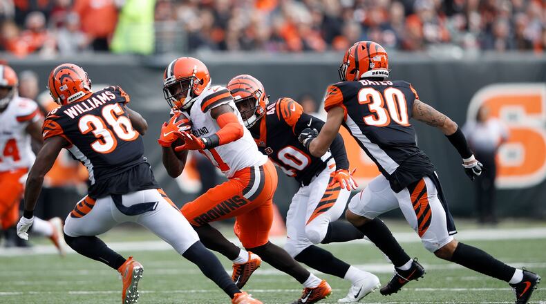 CINCINNATI, OH - NOVEMBER 25: Antonio Callaway #11 of the Cleveland Browns attempts to get past Shawn Williams #36 of the Cincinnati Bengals, Brandon Wilson #40, and Jessie Bates #30 during the second quarter at Paul Brown Stadium on November 25, 2018 in Cincinnati, Ohio. (Photo by Joe Robbins/Getty Images)