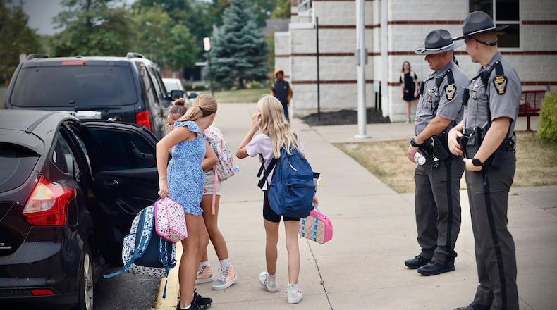 Members of the Ohio State Highway Patrol guard Snowhill Elementary in Springfield as students arrive Tuesday, September 17, 2024. MARSHALL GORBY \STAFF