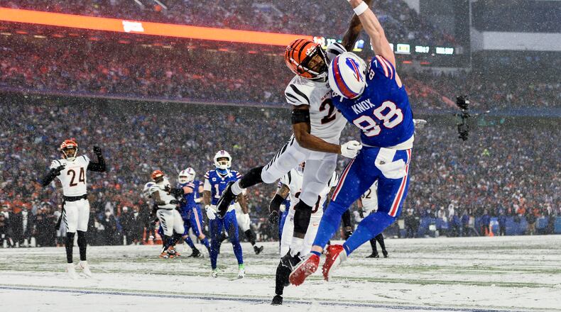 Cincinnati Bengals safety Dax Hill (23) breaks up a pass intended for Buffalo Bills tight end Dawson Knox (88) during the third quarter of an NFL division round football game, Sunday, Jan. 22, 2023, in Orchard Park, N.Y. (AP Photo/Adrian Kraus)