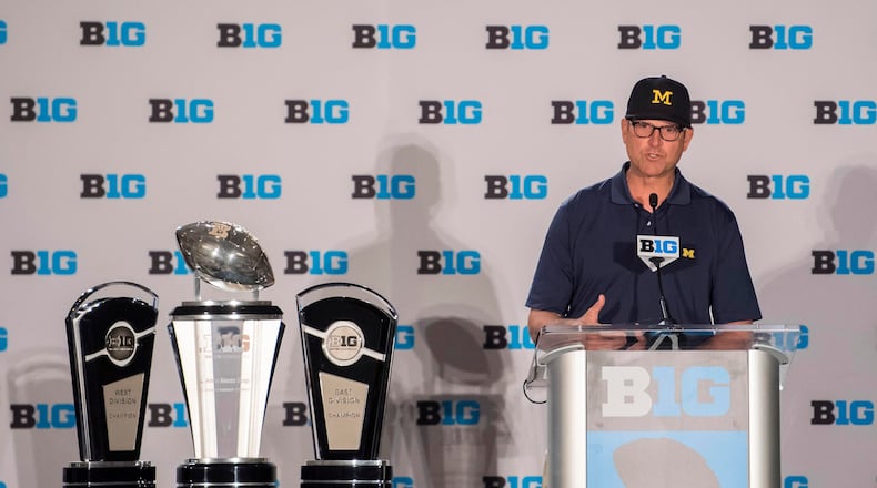 Michigan head coach Jim Harbaugh addresses reporters at Big Ten Media Days.
