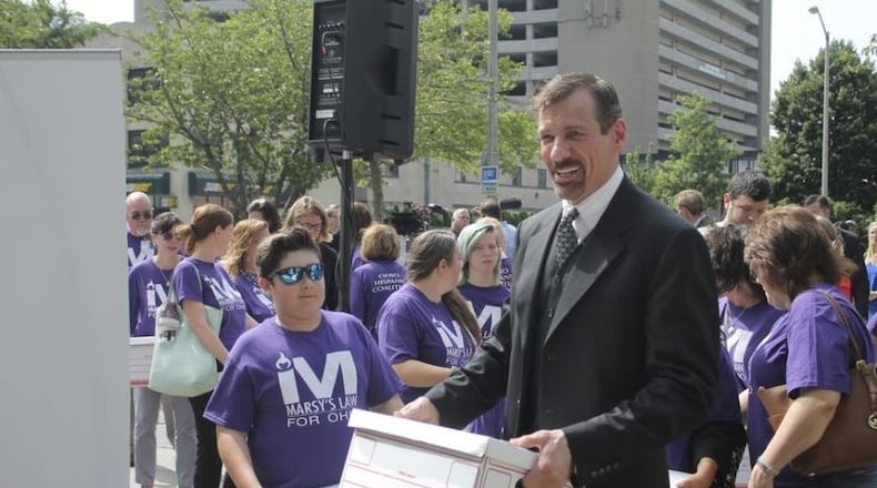 Marsy’s Law founder Henry Nicholas and other supporters of the proposed victims’ right constitutional amendment help carry boxes of petitions into the secretary of state’s office. Marc Kovac/ Gatehouse Media