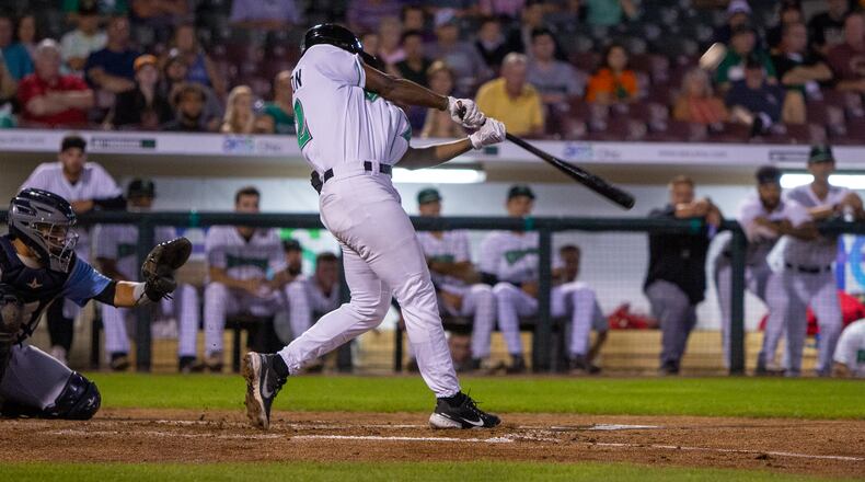 Dragons second baseman Ivan Johnson makes contact during the first inning Tuesday night in his first game in Dayton. He hit a two-run homer in the fourth inning for the Dragons' first hit of the game. Jeff Gilbert/CONTRIBUTED