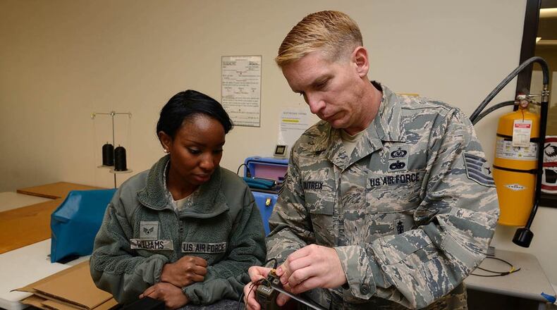 Airman Tabitha Williams, 403rd OSS aircrew flight equipment journeyman, on how to assemble and inspect an AN/URT-44 personnel locator beacon Jan. 10, 2015. The Air Force Life Cycle Management Center’s Agile Combat Support Directorate is currently fielding 12,000 new personnel locator beacons to replace the URT-44. (U.S. Air Force photo)
