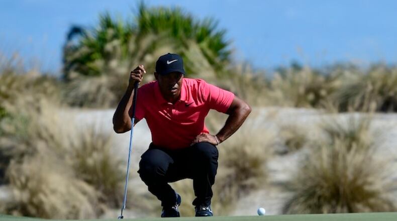 Tiger Woods plans his putt on second hole of the Hero World Challenge at Albany Golf Club in Nassau, Bahamas, Sunday, Dec. 3, 2017. (AP Photo/Dante Carrer)