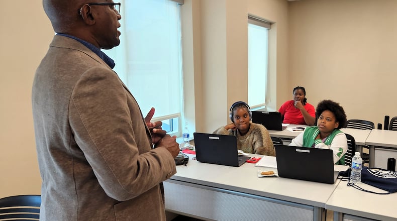 Sinclair Community College Senior Advisor to the President and Chief Diversity Officer Michael Carter talks with recent high school graduates at the Hope Center for Families about success strategies and identifying and achieving goals. Courtesy of Sinclair Community College