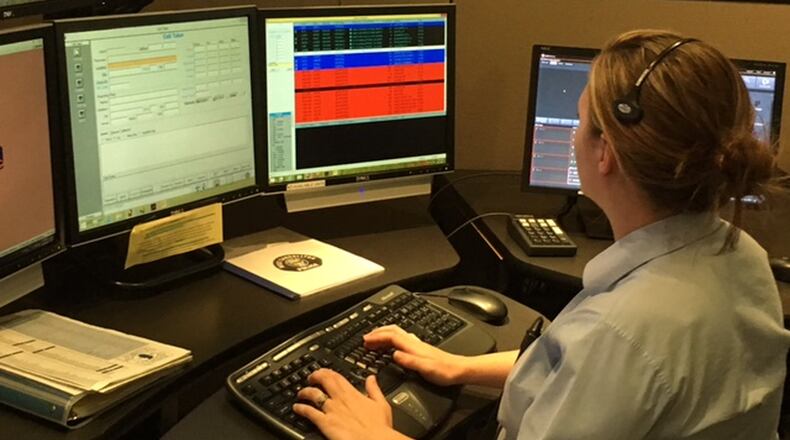 Amanda Holland works in the Centerville Police Department s dispatch center, which handles emergency calls for the city of West Carrollton. The Miami Valley Communications Council is looking to further joint efforts among its members by implementing a fiber ring. NICK BLIZZARD/STAFF PHOTO