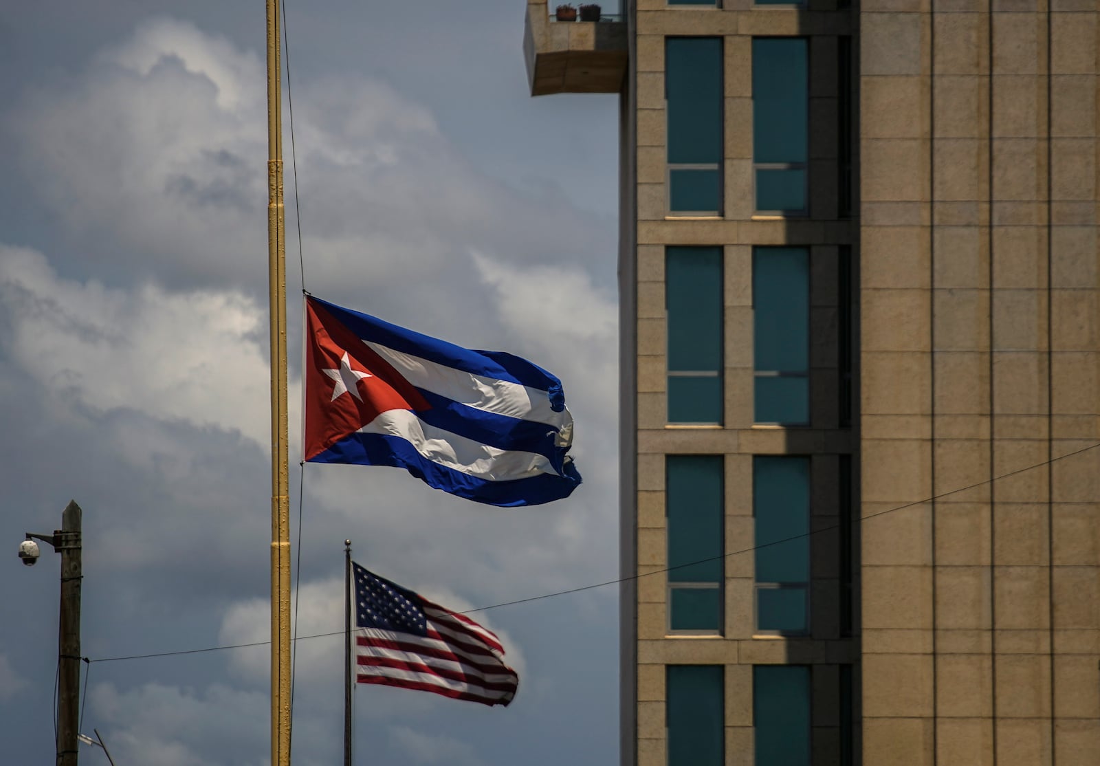 FILE - A Cuban flag is seen next to an American flag outside the U.S. embassy in Havana, Cuba, May 17, 2022. (AP Photo/Ramon Espinosa, File)