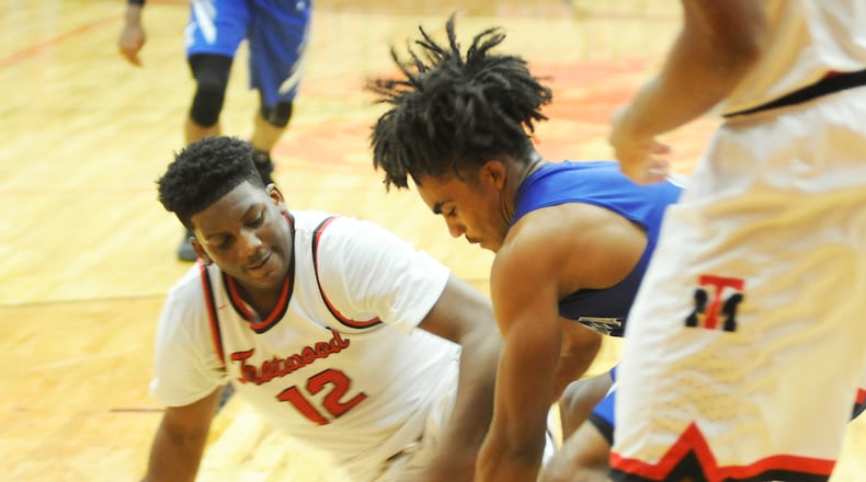 Trotwood’s Malachi Mathews (left) and Xenia’s Dylan Hoosier contend for a loose ball. Trotwood-Madison defeated visiting Xenia 95-60 in a boys high school basketball game on Friday, Dec. 14, 2018. MARC PENDLETON / STAFF