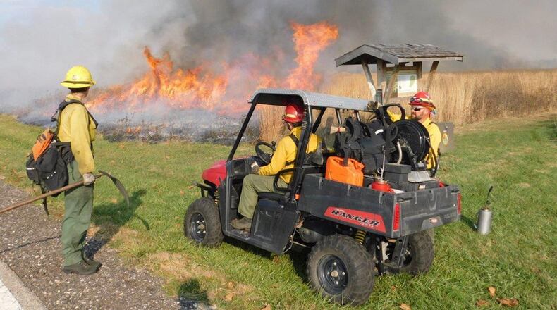 Darryn Warner (far right), Wright-Patterson Air Force Base Wildland Fire Program manager, speaks with Joel Kemm and Krysten Dick from the U. S. Fish and Wildlife Service during a prescribed burn at Huffman Prairie in 2016. (Courtesy photo)