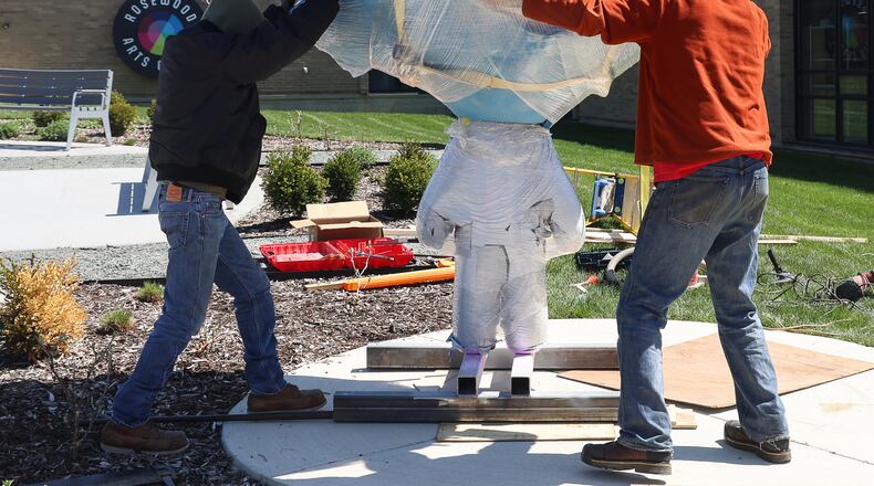 Workers adjust the placement of a sculpture they were installing Tuesday afternoon, April 8, 2025, at Rosewood Arts Center in Kettering. The installation is part of the multi-year Rosewood facility renovation project and was selected from 38 submissions. BRYANT BILLING / STAFF