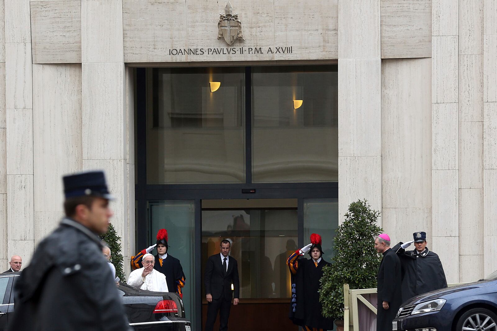 FILE - Pope Francis waves to faithful as he arrives at Vatican's Santa Marta hotel where the Pontiff has his apartment, at the Vatican, March 28, 2013. (AP Photo/Gregorio Borgia, file)