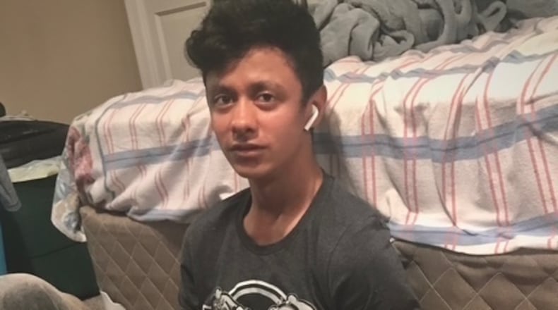 This photo provided by Henry Castro shows Josué Castro Rivera holding a cell phone in Virginia Beach, Va., in April 2021. (Henry Castro via AP)