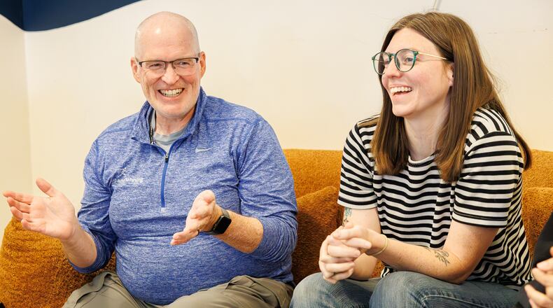Brett Bogan (left) and Natalie Warrick (right) laugh during a group talk about sustainability at Val's Bakery in downtown Dayton on Friday, Aug. 29. Bogan and Warrick have been named Dayton Daily News Community Gems for their work with Waste-Free Dayton, which Warrick founded. BRYANT BILLING / STAFF
