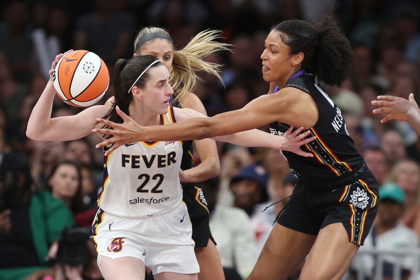 Connecticut Sun's Olivia Nelson-Ododa, right, defends against Indiana Fever's Caitlin Clark (22) during the second half of a WNBA basketball game, Tuesday, July 15, 2025, in Boston. (AP Photo/Michael Dwyer)