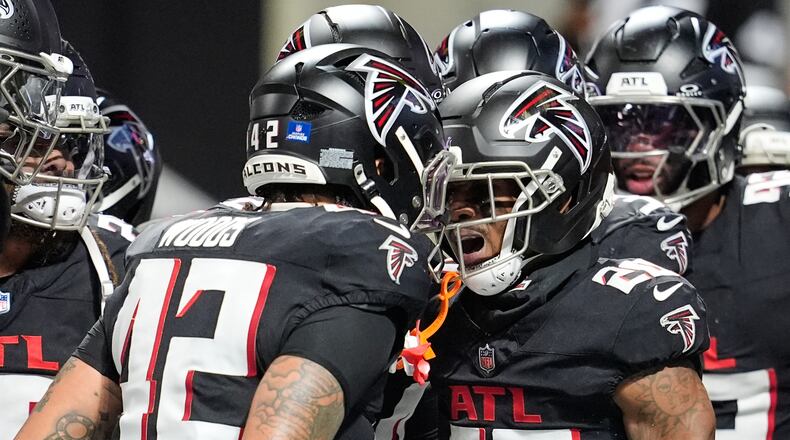 Atlanta Falcons cornerback Dee Alford (20) celebrates his interception with linebacker Josh Woods (42) in the second half of an NFL football game against the New Orleans Saints, Sunday, Jan. 4, 2026, in Atlanta. (AP Photo/Mike Stewart)