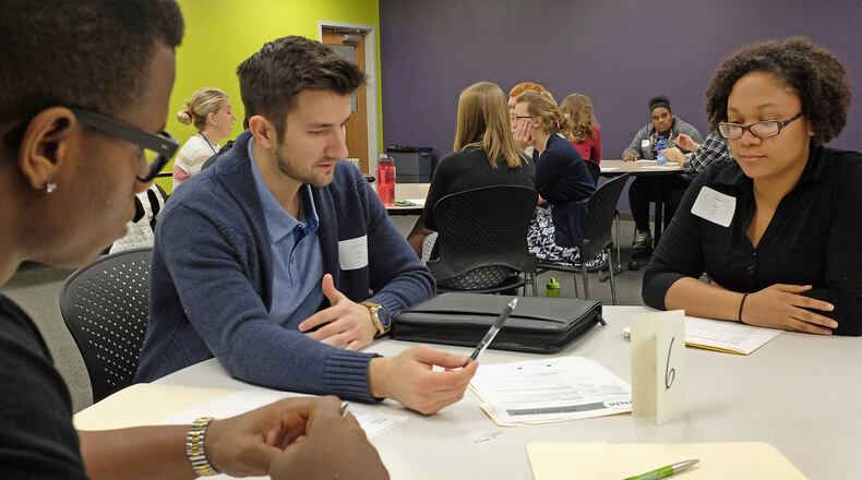 In this February 2017 photo, high School students Malik Young, left, and Jace Moore listen as Steve Newell critiques their resume Thursday during Internship Day at the Career Cennect Center. Bill Lackey/Staff
