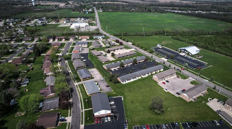 An aerial view of North Hyatt Street in Tipp City, looking northeast, shows the west side of the street heavily developed, but the east side untouched except for the Upper Room Worship Center. There's a new plan to bring almost 300 homes to that side of Hyatt Street. JIM NOELKER/STAFF