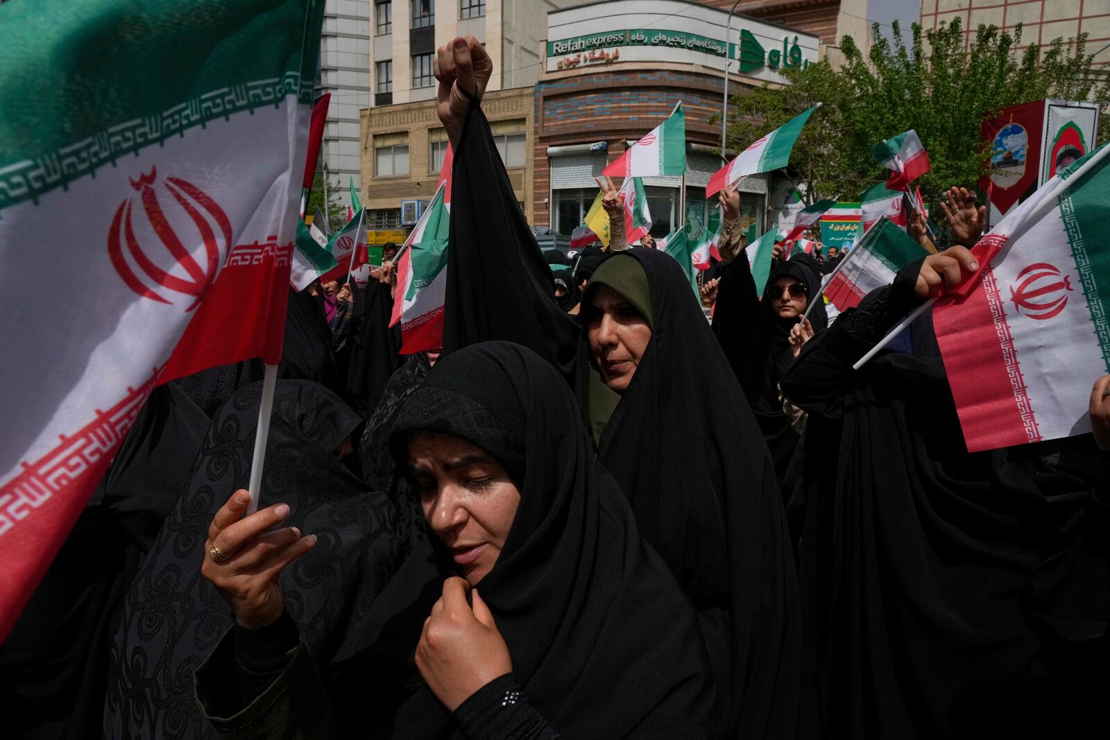 Iranian protesters chant slogans as they wave their country's flags during an anti-Israel demonstration at the Felestin (Palestine) Sq. in Tehran, Iran, Wednesday, April 9, 2025. (AP Photo/Vahid Salemi)