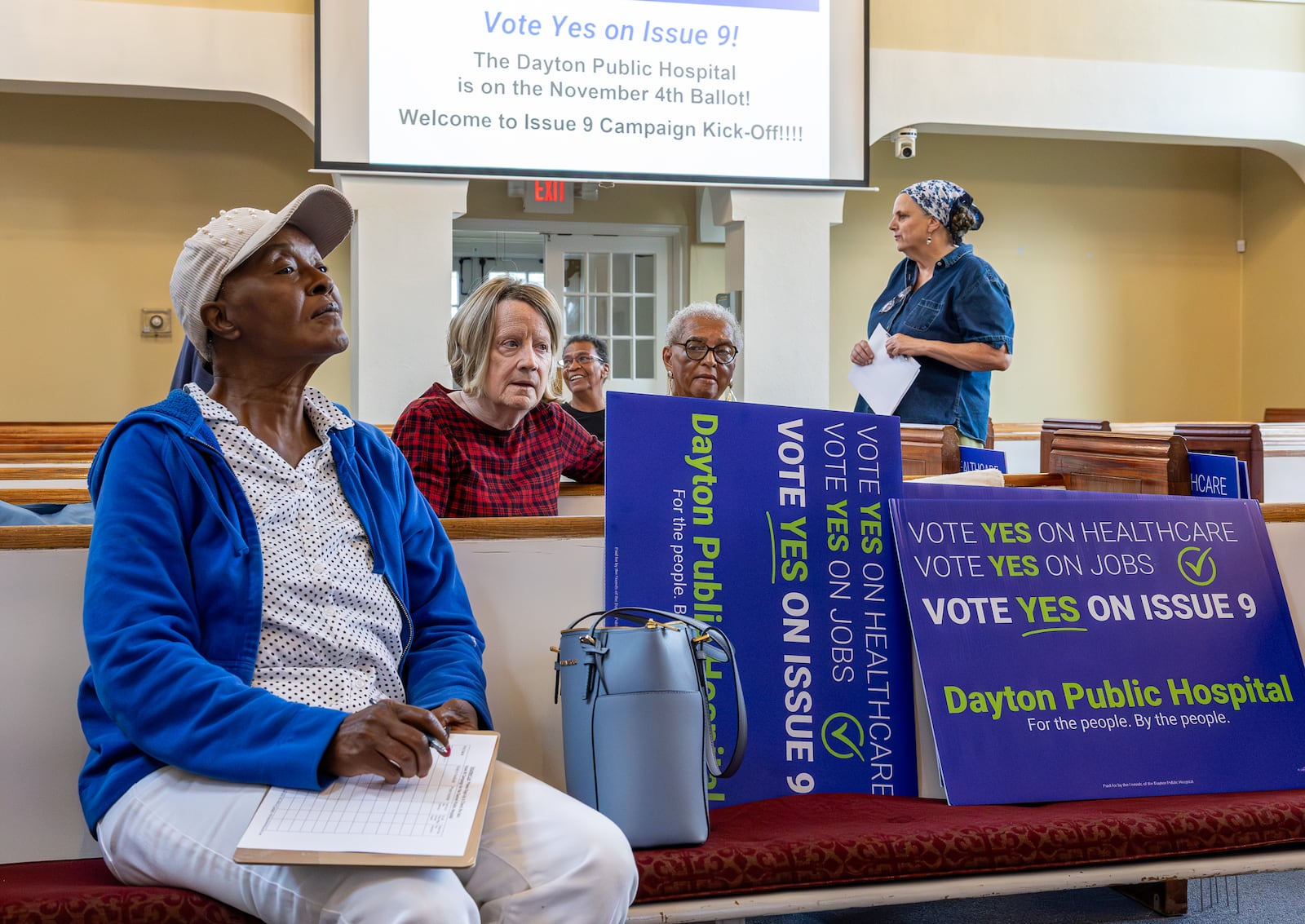 Volunteers who support Issue 9 listen during a meeting on Tuesday, Sept. 23 at College Hill Community Church on Philadelphia Drive in northwest Dayton. If passed, the levy would raise $2 million annually to try to help create a new public hospital in West Dayton. BRYANT BILLING / STAFF