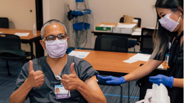 Dr. Vipul Patel, chief of critical care at Dayton Children's Hospital, is among first staff members to receive the COVID-19 vaccine Tuesday, Dec. 22, 2020.