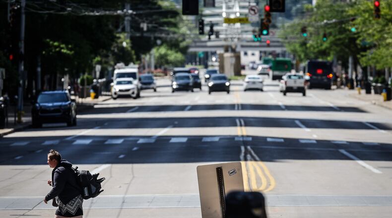 A pedestrian walks across North Main Street at First Street looking south. The city wants to make improvements on North Main Street from Monument Ave. to Sixth Street. JIM NOELKER/STAFF