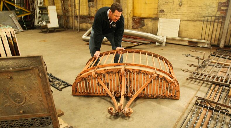 Owner James Kent moves an architectural detail salvaged from Shawen Acres at The Architectural Reuse Store at 280 N. Findlay St.