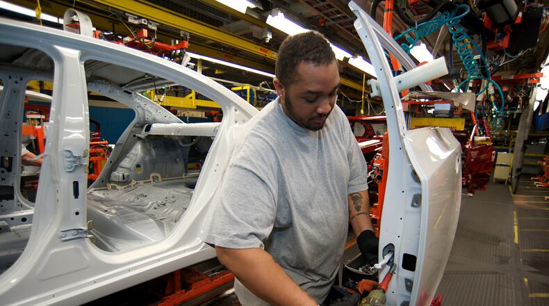 Kytwon Norman of Youngstown, Ohio, assembles the door of a Chevy Cruze at the Lordstown GM plant in this file photo. The plant is slated for probable closure, affecting 1,600 workers. (Jason Miller/MCT)