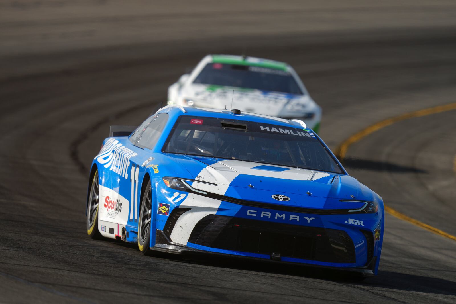 Denny Hamlin drives through Turn 3 during a NASCAR Cup Series auto race at Pocono Raceway, Sunday, June 22, 2025, in Long Pond, Pa. (AP Photo/Derik Hamilton)
