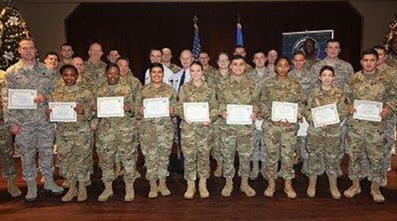 Col. Thomas Sherman (left), 88th Air Base Wing commander, Chief Master Sgt. Stanley Cadell (right), Air Force Materiel command chief, and Chief Master Sgt. Joseph Newton (second from right), 88th Mission Support Group superintendent, celebrate the newest Team Wright-Patt enlisted promotees during a ceremony at the Wright-Patterson Club Dec. 30. (U.S. Air Force photo/Thomas Lewis)