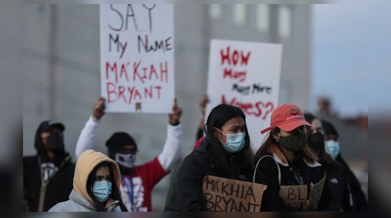 People listen as friends of Ma'Khia Bryant speak about her at a community vigil, on Wednesday, April 21, 2021, at Douglas Elementary School in Columbus, Ohio. Body camera video released Wednesday shows a Columbus officer fatally shoot Bryant, who swung at two other people with a knife. (Joshua A. Bickel/The Columbus Dispatch via AP)