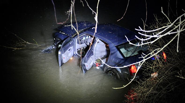 A pursuit that started in Donnelsville in Clark County ended after the car went off Scarff Road near New Carlisle and into a creek in Miami County. One suspect was taken into custody and the second ran from the scene. MARSHALL GORBY/STAFF