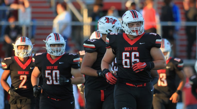 Wayne lineman Josh Padilla leads the offense onto the field during a game against Springfield on Friday, Sept. 10, 2021, in Huber Heights. Padilla is a member of Ohio State's 2023 recruiting class. David Jablonski/Staff
