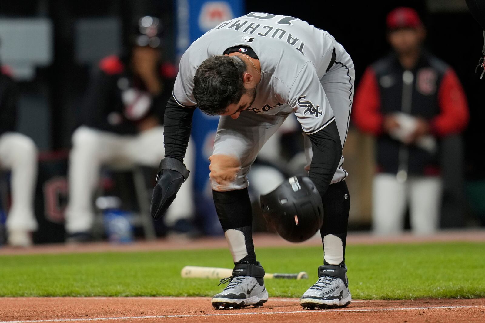 Chicago White Sox's Mike Tauchman slams his helmet down after being tagged out by Cleveland Guardians catcher Austin Hedges in the ninth inning of a baseball game in Cleveland, Wednesday, April 9, 2025. (AP Photo/Sue Ogrocki)