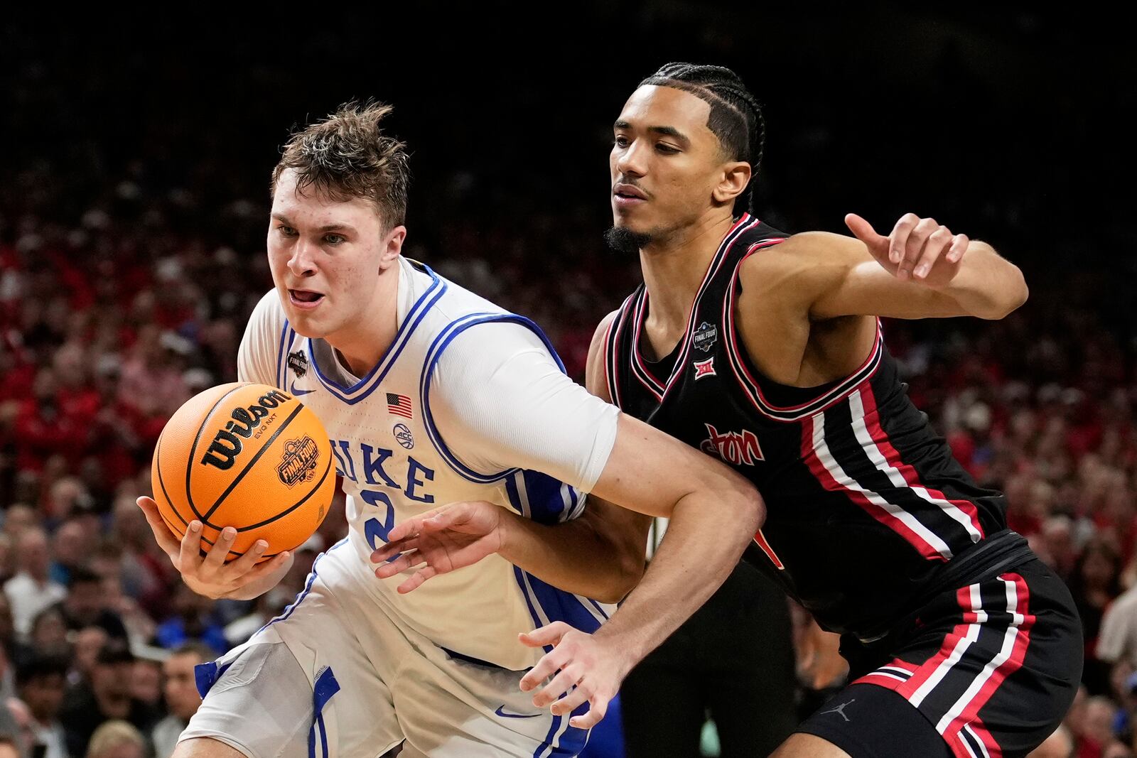 Duke forward Cooper Flagg drives to the basket past Houston forward Joseph Tugler during the second half in the national semifinals at the Final Four of the NCAA college basketball tournament, Saturday, April 5, 2025, in San Antonio. (AP Photo/Brynn Anderson)