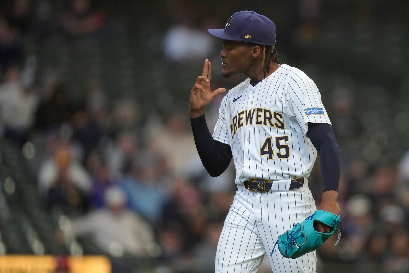 Milwaukee Brewers' Abner Uribe gestures as he walks to the dugout during the seventh inning of a baseball game against the Cincinnati Reds, Sunday, April 6, 2025, in Milwaukee. (AP Photo/Aaron Gash)