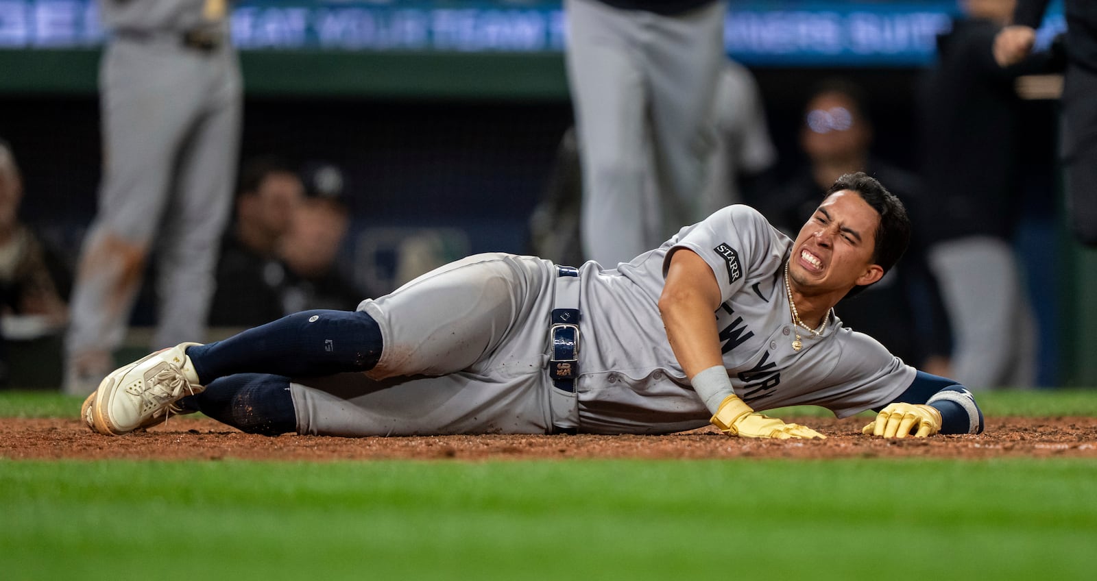New York Yankees' Oswaldo Cabrera reacts after injuring his leg while scoring a run during the ninth inning of a baseball game against the Seattle Mariners, Monday, May 12, 2025, in Seattle. (AP Photo/Stephen Brashear)