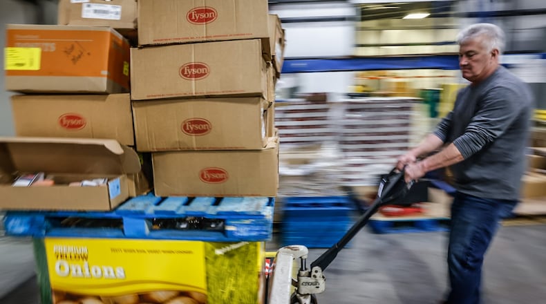 FoodBank employee, Tom Derringer unloads a truck with food from Sam's Club Wednesday March 1, 2023 at the warehouse on Armor Place in Dayton. JIM NOELKER/STAFF