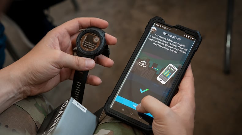 A Guardian syncs data from a wearable device to a phone during a Continuous Fitness Assessment, or CFA, study informational session hosted by an Air Force Research Laboratory team at a facility near Wright-Patterson Air Force Base, June 8, 2023. The CFA study is a two-year voluntary effort with Guardians to assess the use of wearable fitness devices that measure physical activity. The CFA is part of the U.S. Space Force’s Holistic Health Approach, an initiative that promotes wellness through positive behaviors and seeks to replace traditional military fitness tests with data from continuous monitoring technology. (U.S. Space Force photo / Rick Eldridge).