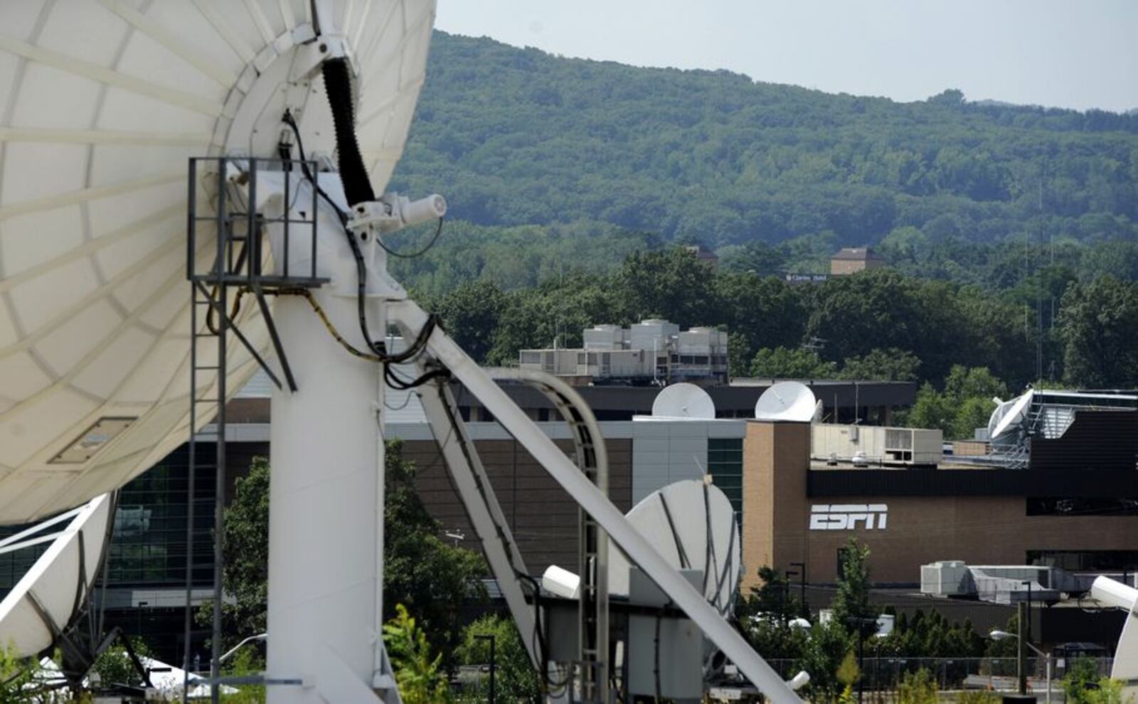 FILE - In this Aug. 2, 2011 file photo, satellite dishes dot the campus of ESPN in Bristol, Conn. ESPN has begun removing its videos from YouTube due to rights and legal issues surrounding next week’s launch of YouTube’s ad-free subscription service, Red. (AP Photo/Jessica Hill, File)